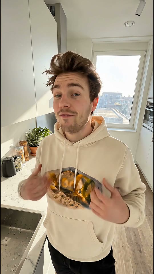 A creator presenting a printed hoodie in a casual setting